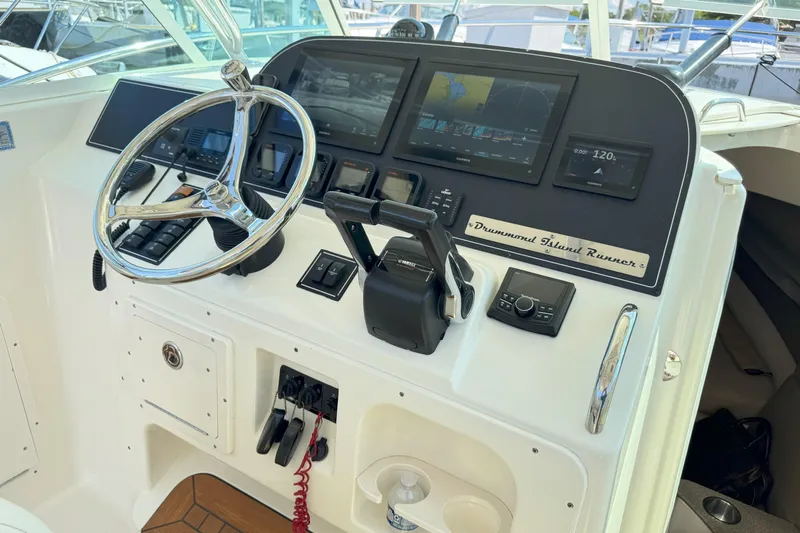  Yacht Photos Pics Helm of 2006 Pursuit LS 345 Drummond Runner with steering wheel and navigation displays.