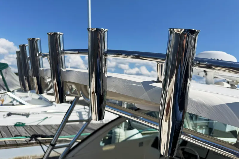  Yacht Photos Pics Chrome rod holders on a 2006 Pursuit LS 345 Drummond Runner boat, docked under blue skies.