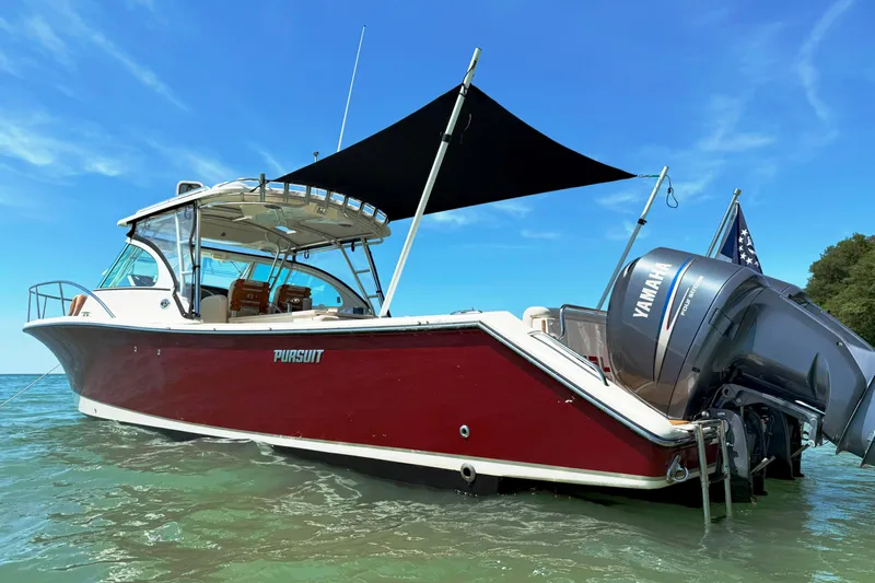  Yacht Photos Pics 2006 Pursuit LS 345 Drummond Runner boat with Yamaha engine on clear water.