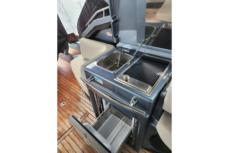  Yacht Photos Pics 2023 Cranchi M44 HT yacht kitchen with grill and sink on teak deck.