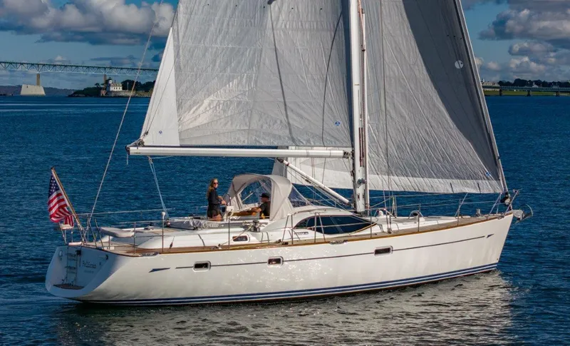 Dolce Vita Yacht Photos Pics 2008 Oyster 46 sailboat cruising on calm waters under a clear sky.