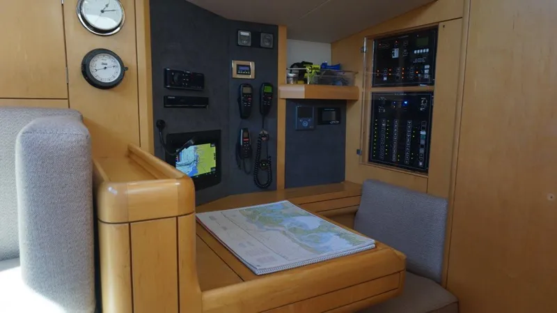 Dolce Vita Yacht Photos Pics Navigation station inside 2008 Oyster 46 yacht with control panels and map.