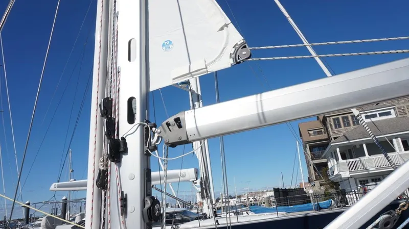 Dolce Vita Yacht Photos Pics Sailboat mast and rigging of 2008 Oyster 46 against a clear blue sky.