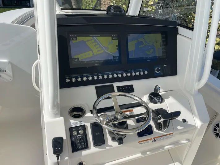  Yacht Photos Pics 2023 Regulator 31 boat dashboard with dual navigation screens and controls.