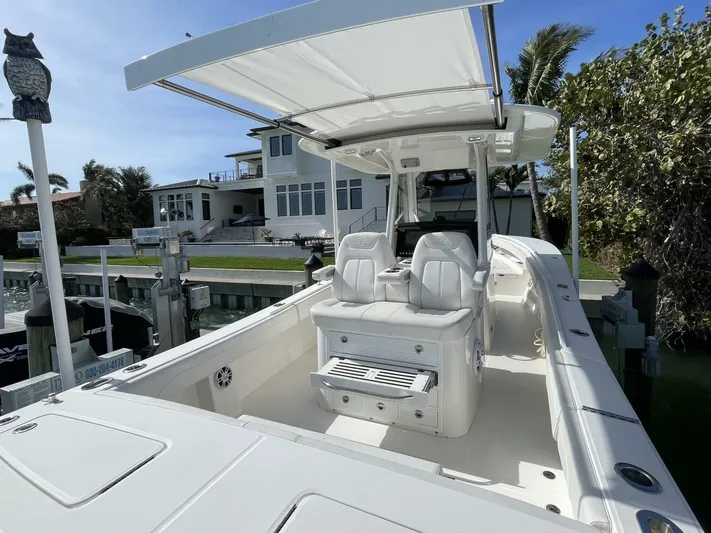  Yacht Photos Pics 2023 Regulator 31 boat docked, featuring sleek white seating and canopy.