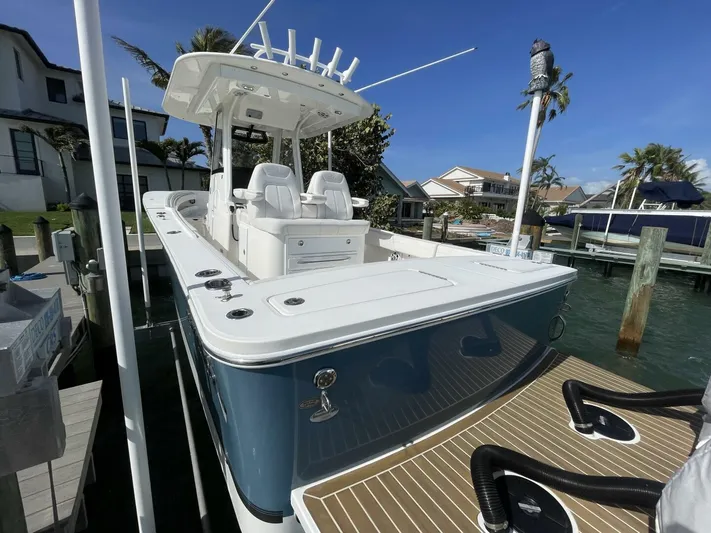  Yacht Photos Pics 2023 Regulator 31 boat docked at marina, featuring sleek design and modern amenities.