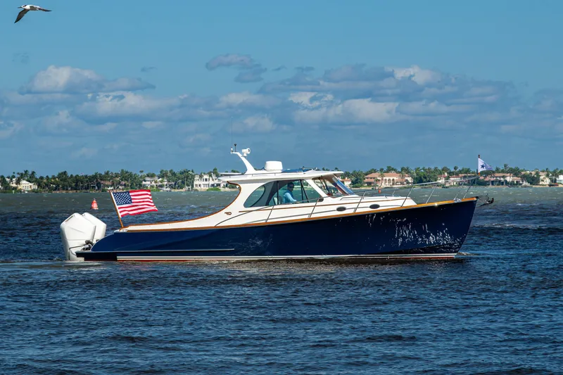 King's Landing Yacht Photos Pics 2024 Hinckley 35 boat cruising on open water with American flag.