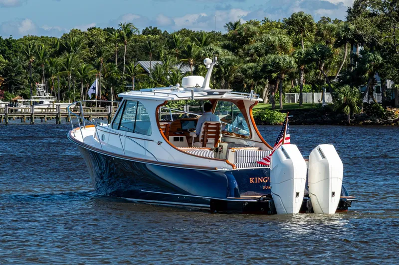 King's Landing Yacht Photos Pics 2024 Hinckley 35 boat cruising on a scenic waterway with lush greenery.