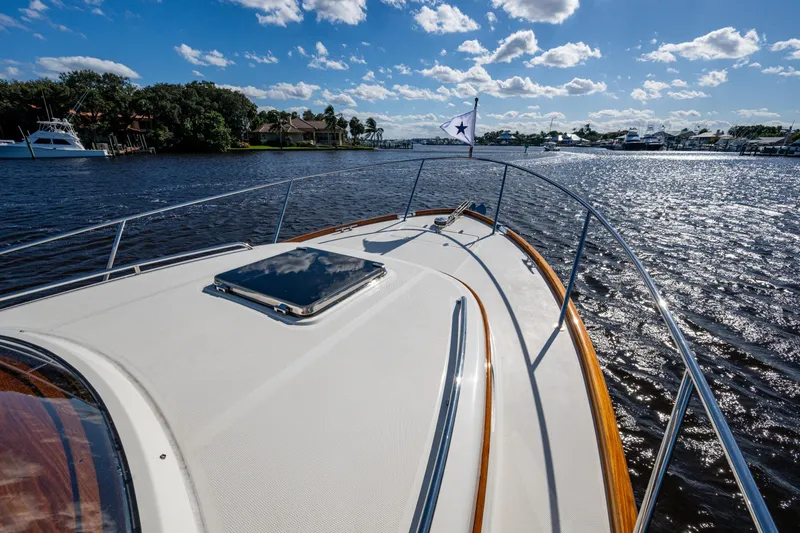 King's Landing Yacht Photos Pics 2024 Hinckley 35 yacht cruising on a sunny day with scenic waterfront views.