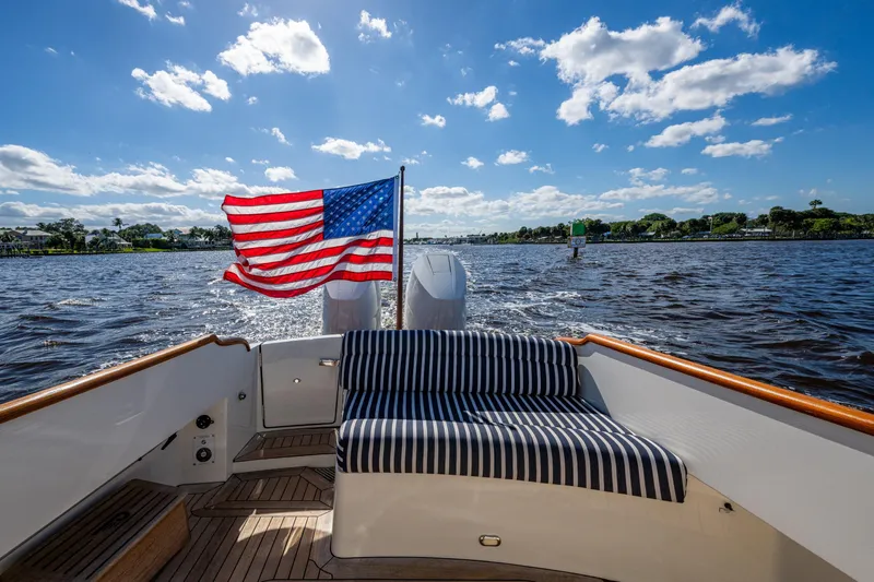King's Landing Yacht Photos Pics 2024 Hinckley 35 boat with American flag, cruising on a sunny day.