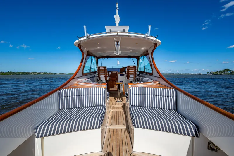 King's Landing Yacht Photos Pics 2024 Hinckley 35 yacht with striped seating, cruising on a sunny day.