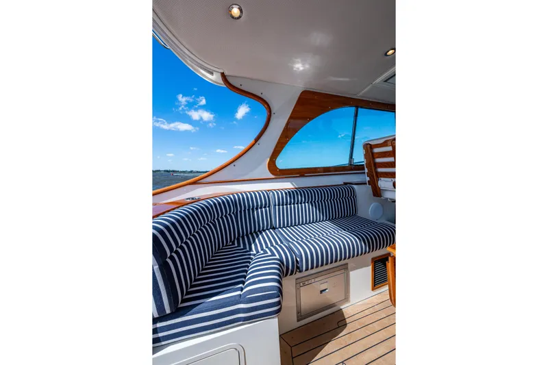 King's Landing Yacht Photos Pics 2024 Hinckley 35 yacht interior with striped seating and ocean view.