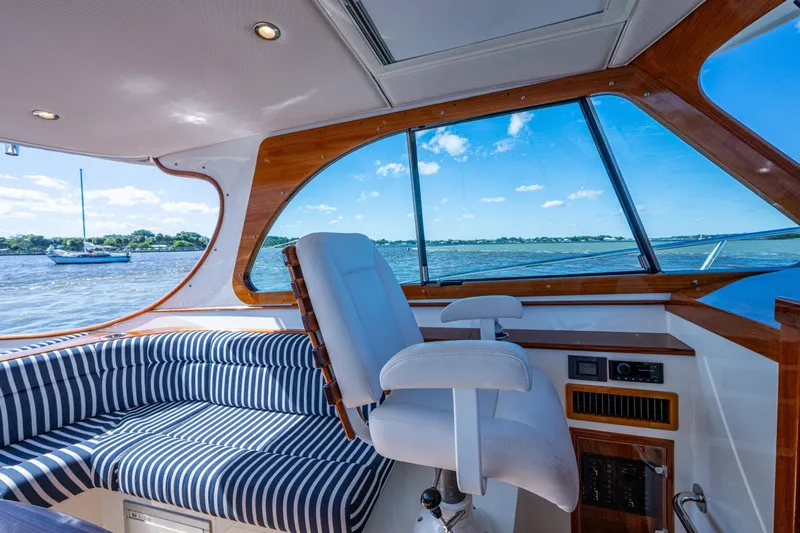 King's Landing Yacht Photos Pics Interior of 2024 Hinckley 35 yacht with striped seating and scenic water view.