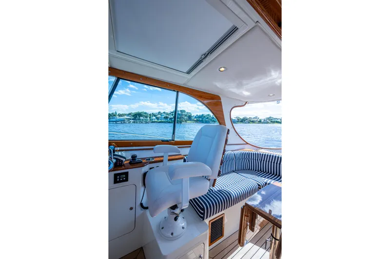 King's Landing Yacht Photos Pics Interior of 2024 Hinckley 35 yacht with striped seating and water view.