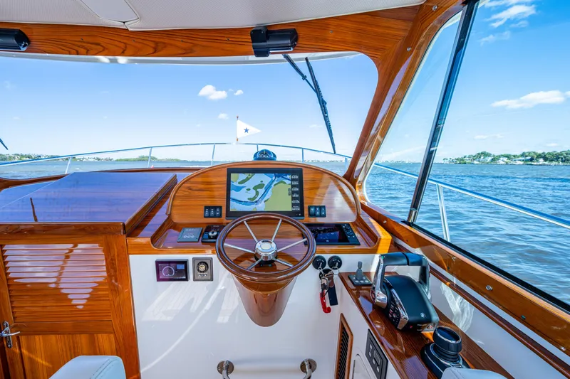 King's Landing Yacht Photos Pics Helm of 2024 Hinckley 35 yacht with wooden finish and navigation display.
