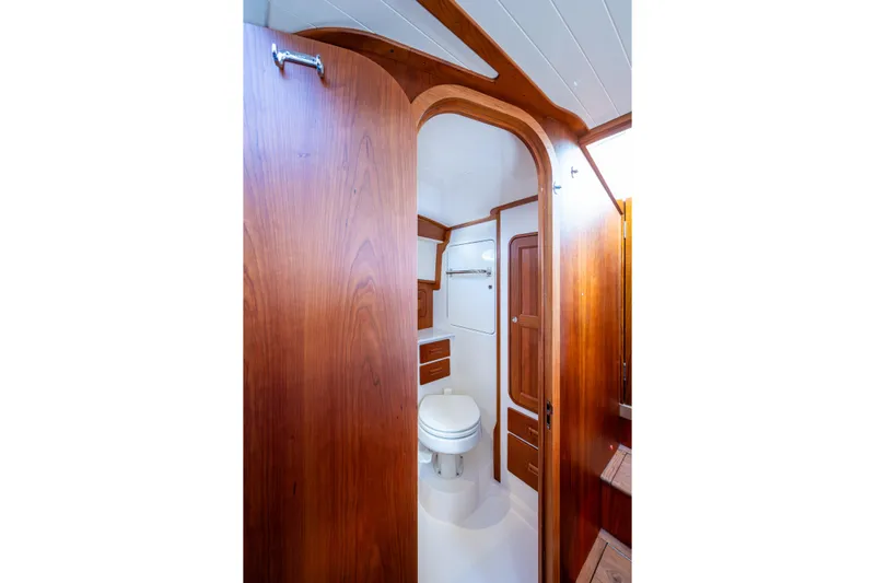 King's Landing Yacht Photos Pics 2024 Hinckley 35 yacht bathroom with elegant wood finish and modern amenities.