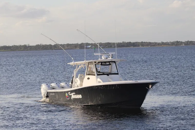 No Name Yacht Photos Pics 2021 Regulator 41 boat cruising on calm waters with fishing rods.