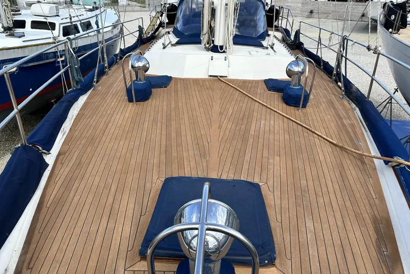 Wind Seeker 1 Yacht Photos Pics Deck view of a 1989 Windship 60 sailboat with wooden finish and blue accents.