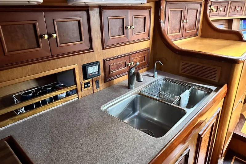 Wind Seeker 1 Yacht Photos Pics Luxurious wooden kitchen interior of 1989 Windship 60 yacht with double sink.