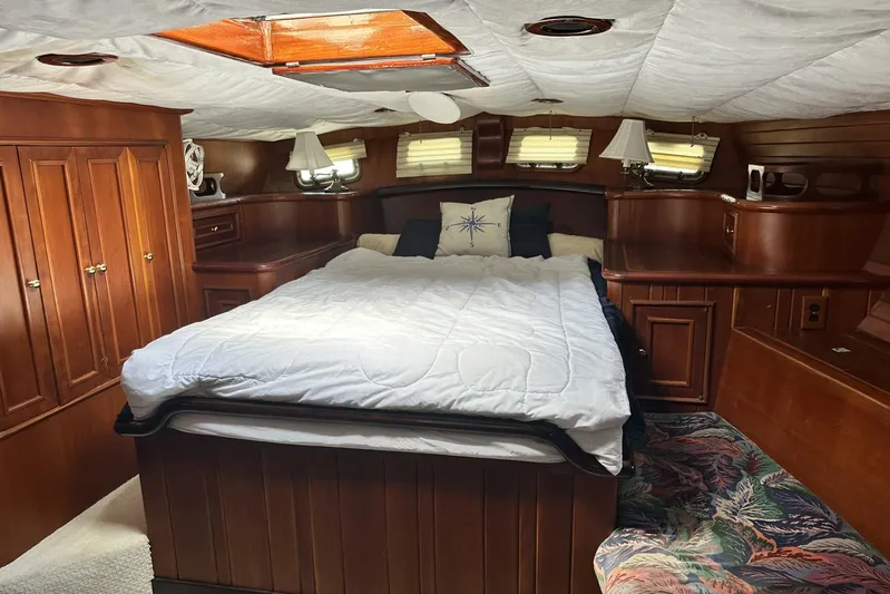 Wind Seeker 1 Yacht Photos Pics Luxurious cabin interior of 1989 Windship 60 yacht with cozy bed and wooden furnishings.