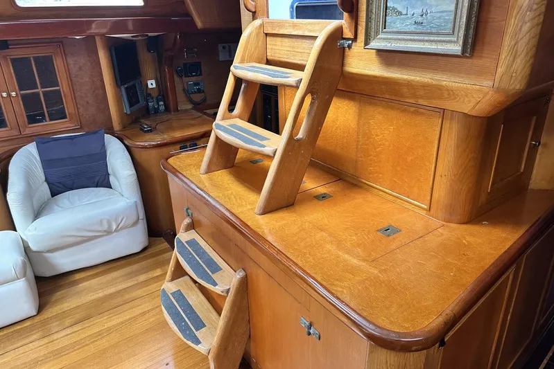 Wind Seeker 1 Yacht Photos Pics Interior of 1989 Windship 60 yacht with wooden cabinetry and seating area.