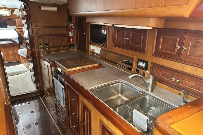 Wind Seeker 1 Yacht Photos Pics Luxurious 1989 Windship 60 yacht interior with wooden cabinetry and modern kitchen amenities.