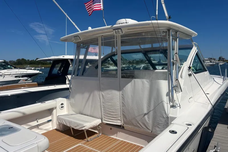  Yacht Photos Pics 2008 Tiara Yachts 3200 Open docked, featuring a sleek design and American flag.