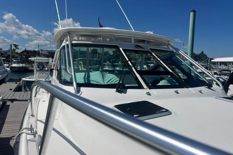  Yacht Photos Pics 2008 Tiara Yachts 3200 Open docked, showcasing sleek design and polished railings under a clear sky.