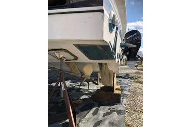  Yacht Photos Pics 2008 Tiara Yachts 3200 Open on dry dock, showing hull and outboard motor.