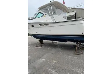  Yacht Photos Pics 2008 Tiara Yachts 3200 Open boat on stands, white hull, outdoor setting.