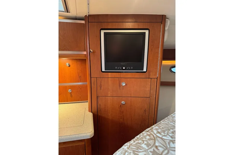  Yacht Photos Pics 2008 Tiara Yachts 3200 Open interior with wood cabinetry and built-in TV.