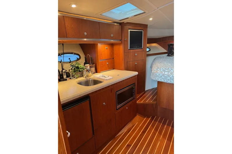  Yacht Photos Pics Luxurious 2008 Tiara Yachts 3200 Open interior with kitchenette and cozy sleeping area.