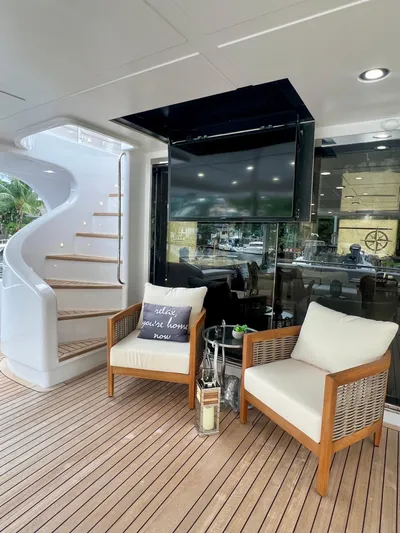 Panacea Yacht Photos Pics Luxury yacht deck with seating, spiral staircase, and TV; Mengi Yay 115 MY, 2011 model.