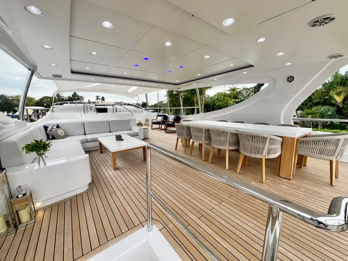 Panacea Yacht Photos Pics Luxurious 2011 Mengi Yay 115 MY yacht deck with elegant seating and dining area.
