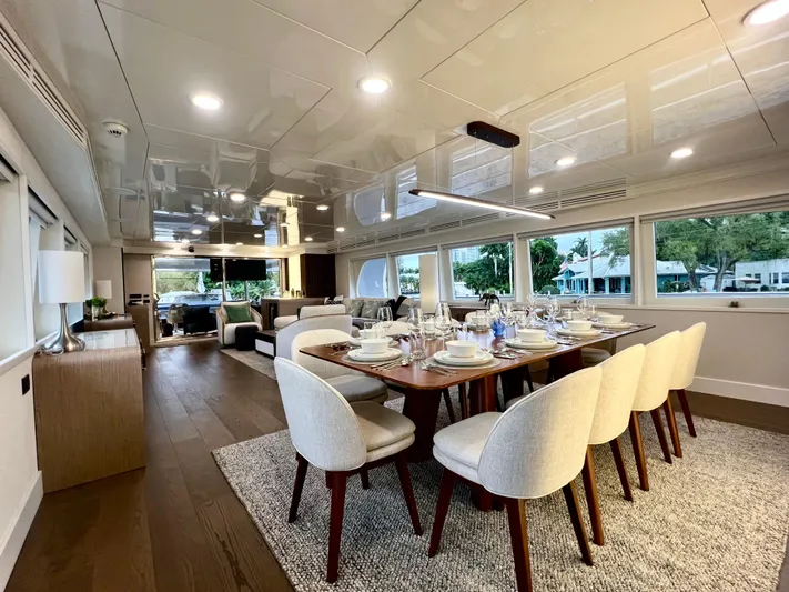 Panacea Yacht Photos Pics Luxurious dining area on 2011 Mengi Yay 115 MY yacht, featuring elegant table settings.