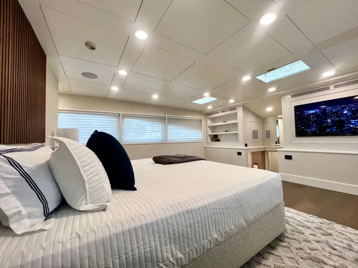 Panacea Yacht Photos Pics Luxurious bedroom interior on 2011 Mengi Yay 115 MY yacht, featuring modern design and ambient lighting.