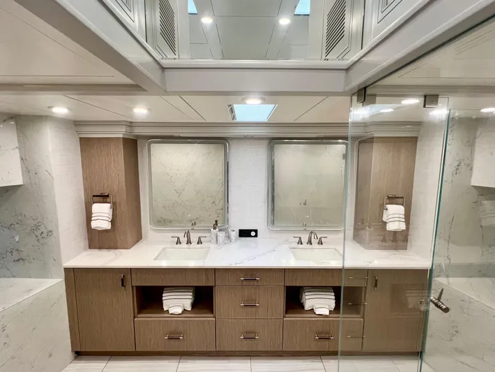 Panacea Yacht Photos Pics Luxurious yacht bathroom with dual sinks, modern fixtures, and elegant wood cabinetry on Mengi Yay 115 MY.