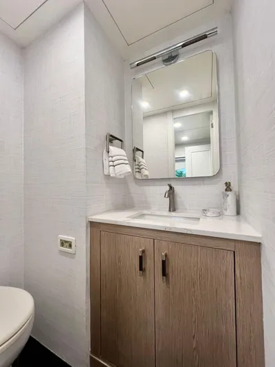 Panacea Yacht Photos Pics Luxurious bathroom on 2011 Mengi Yay 115 MY yacht with modern fixtures and wooden cabinetry.