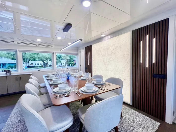 Panacea Yacht Photos Pics Luxurious dining area on 2011 Mengi Yay 115 MY yacht, featuring elegant table settings.