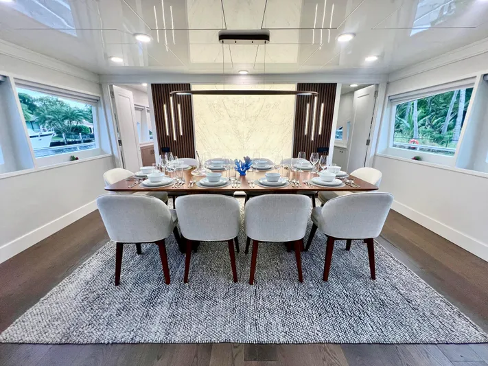 Panacea Yacht Photos Pics Luxurious dining area on 2011 Mengi Yay 115 MY yacht, elegantly set table.