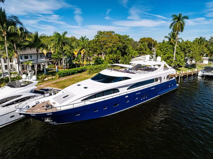 Panacea Yacht Photos Pics Luxurious 2011 Mengi Yay 115 MY yacht docked by palm trees and waterfront homes.