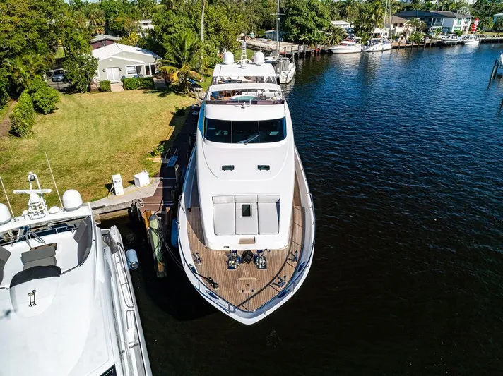 Panacea Yacht Photos Pics Aerial view of 2011 Mengi Yay 115 MY yacht docked by lush greenery.