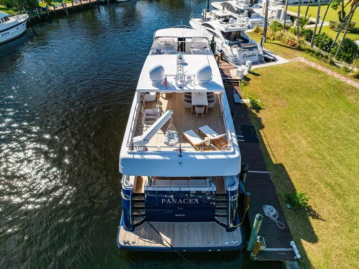 Panacea Yacht Photos Pics Luxury yacht Mengi Yay 115 MY, 2011, docked in a serene marina setting.