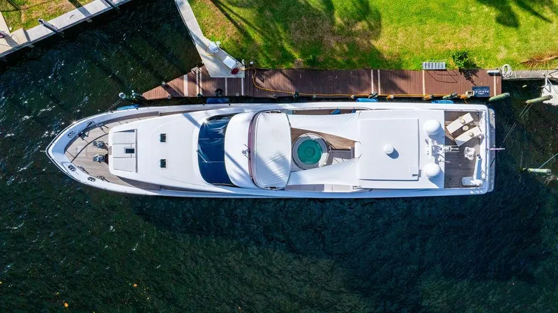 Panacea Yacht Photos Pics Aerial view of 2011 Mengi Yay 115 MY yacht docked by a grassy shore.