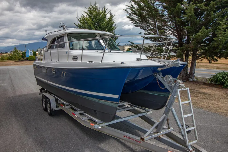R Time Yacht Photos Pics 2013 Aspen C90 boat on trailer, parked outdoors under cloudy sky.