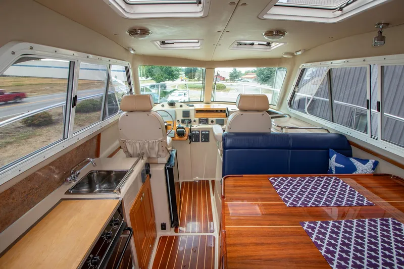 R Time Yacht Photos Pics Interior of 2013 Aspen C90 boat with kitchen, seating, and helm.