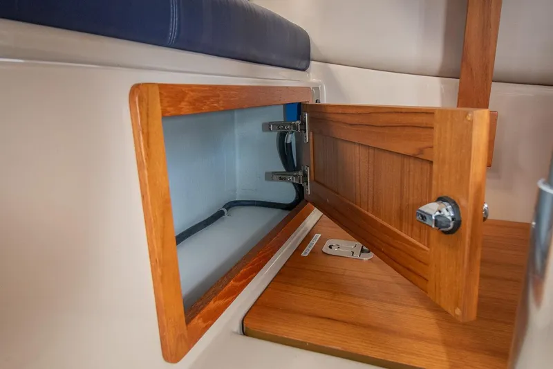 R Time Yacht Photos Pics Open wooden storage compartment on 2013 Aspen C90 boat interior.