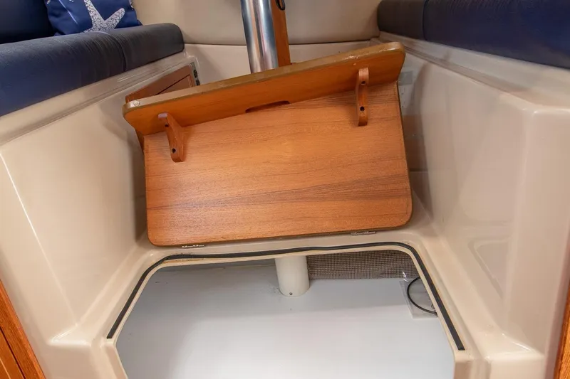 R Time Yacht Photos Pics Interior of 2013 Aspen C90 boat with wooden table and seating area.