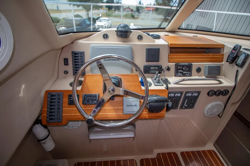 R Time Yacht Photos Pics 2013 Aspen C90 boat cockpit with Garmin navigation, wooden dashboard, and control panels.