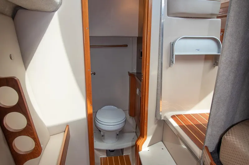 R Time Yacht Photos Pics 2013 Aspen C90 boat interior with compact bathroom and wooden accents.